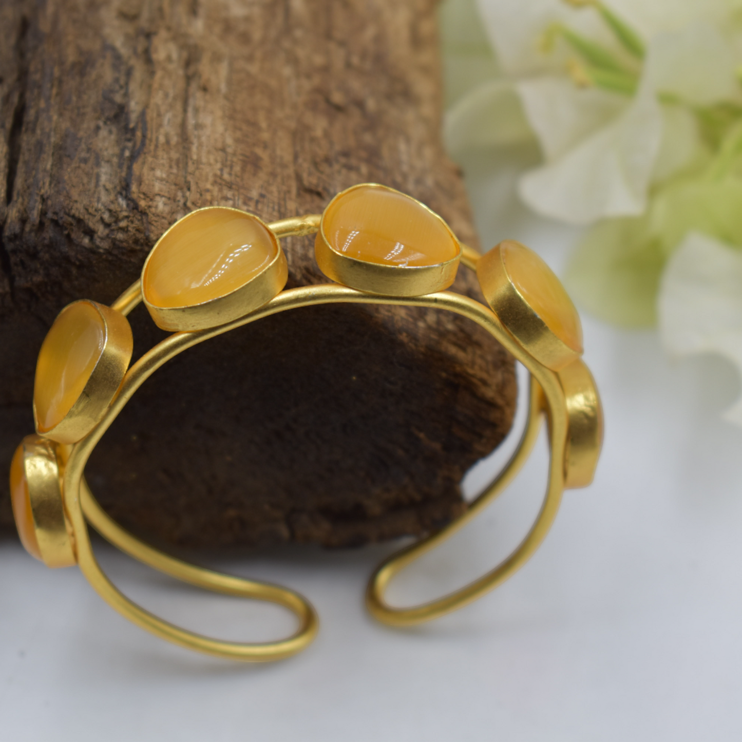 A piece of stone goldplated brass bangle