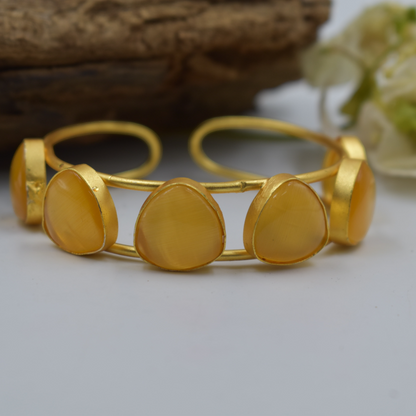 A piece of stone goldplated brass bangle